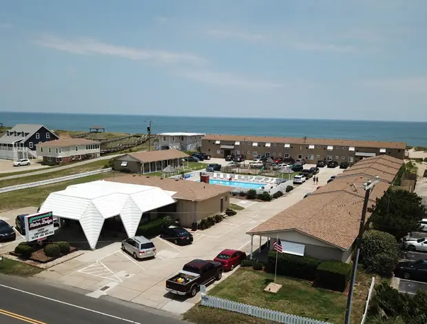 An aerial view of the motel from Virginia Dare Trail, showing the office, the pool and the ocean beyond