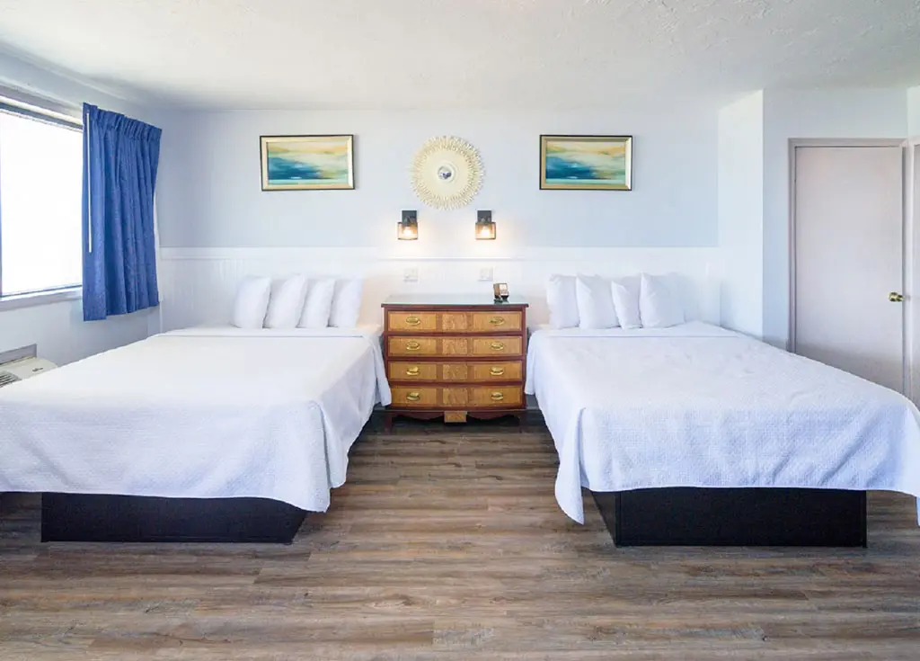 Queen beds in a second-floor oceanfront two-room unit