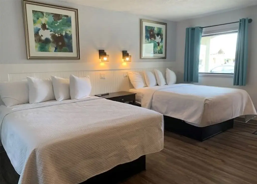 Two queen beds in a poolside efficiency room