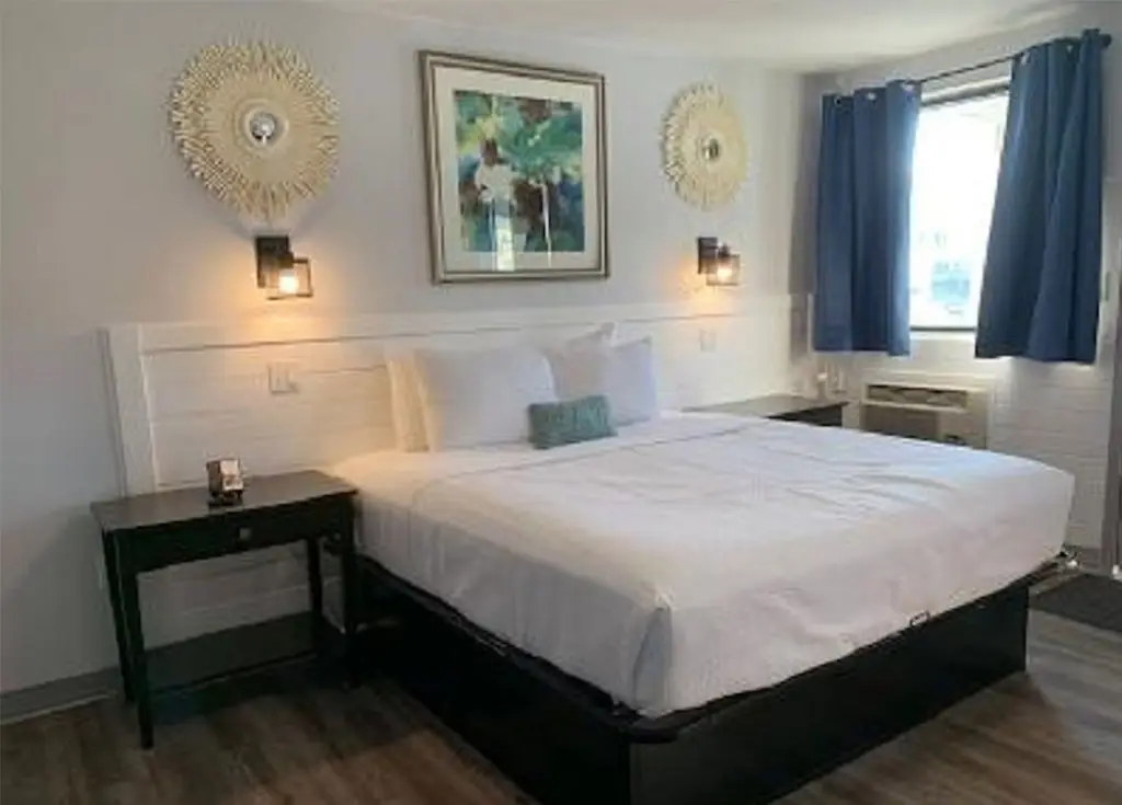 King bed in a poolside efficiency room at Outer Banks Motor Lodge