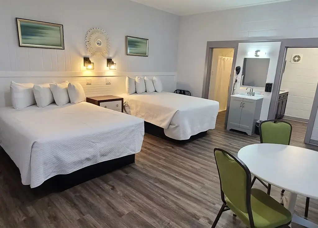 Two queen beds in a pet-friendly poolside patio room